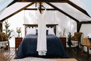 Wedding Gown Hanging in Glamping Wall Tent